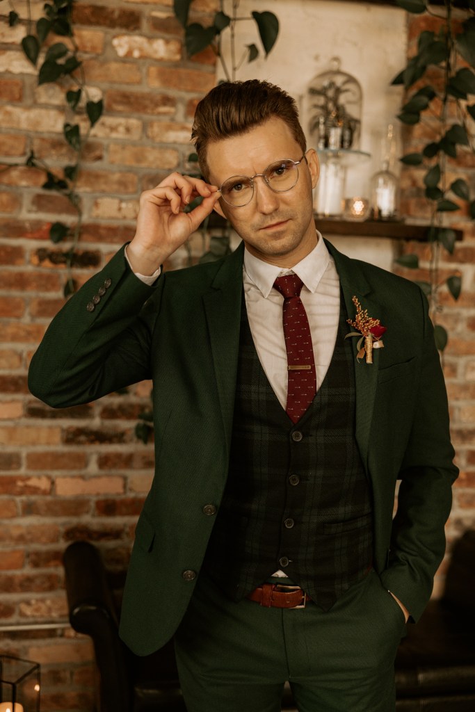 groom portrait with glasses in green suit